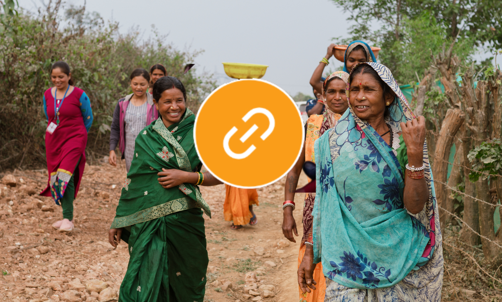 Women with headcoverings walking a path in India.